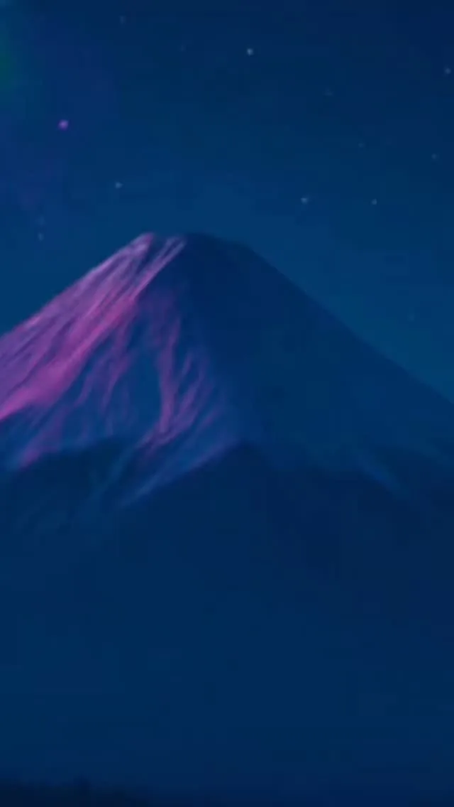Purple mountain beneath a dark blue sky in the Muladhara reel